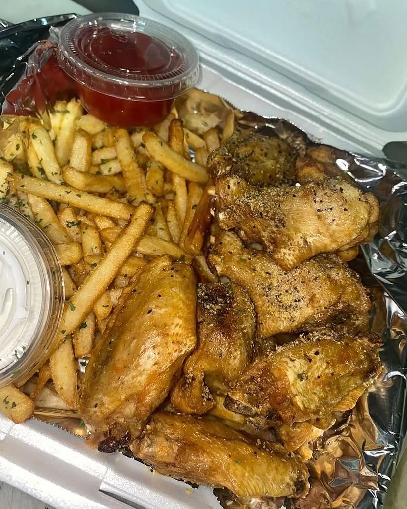 Seasoned wings with fries and dipping sauces