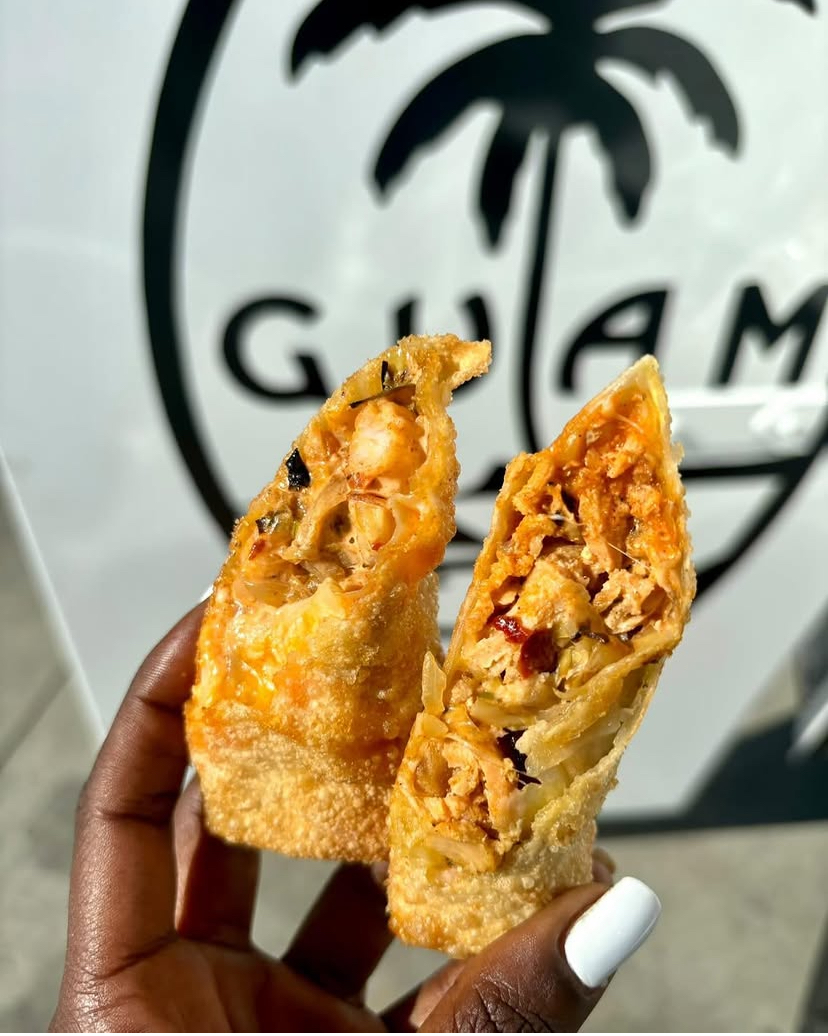 Two freshly fried filled egg rolls